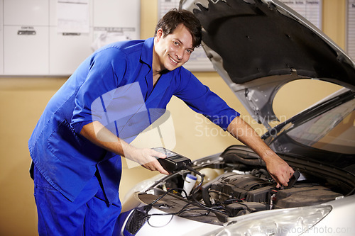 Image of Smile, portrait and a mechanic with a car for maintenance, battery repair or work on an engine. Happy, workshop and a man, or prerson building a vehicle or transport in a garage for motor inspection