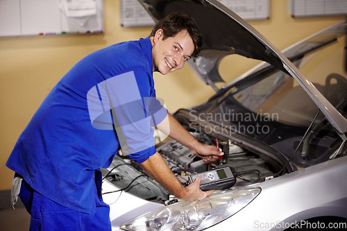 Image of Portrait, car and repair with a mechanic man in a workshop as an engineer looking at the engine of a vehicle. Garage, service or quote with a young technician working under the hood of an automobile