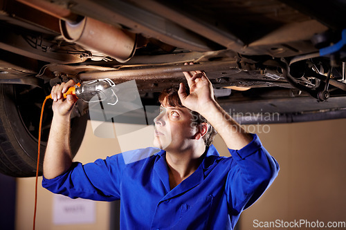 Image of Car, maintenance or service with a mechanic man in a garage for a report on a vehicle repair for insurance. Inspection, professional and expertise with a young engineer in a workshop for assessment