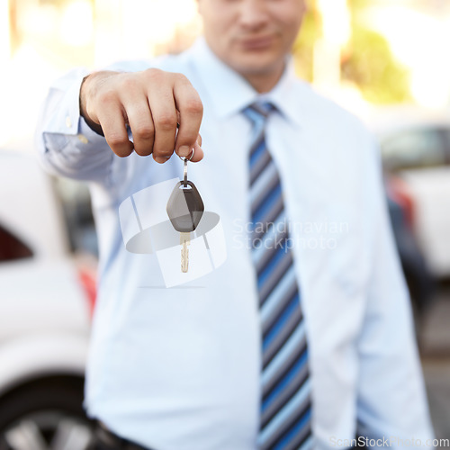 Image of Businessman, hand and key to car outdoor with sale of auto, transportation and investment. Vehicle, dealership or man with keys in parking lot from salesman for test drive, opportunity or driving