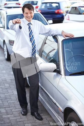 Image of Businessman, portrait and key in hand to car with sale of auto, transportation and investment. Vehicle, dealership or man with keys in parking lot from salesman for test drive, opportunity or driving