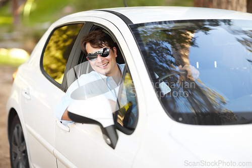 Image of Happy, portrait and a man in a car for travel, drive or a journey on the road. Smile, morning and a person or driver in a vehicle, motor or transport for driving for a trip, traveling or a commute
