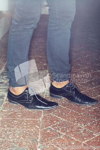 Image of Shoes, legs and closeup of man feet by brick floor for an elegant, stylish and trendy outfit. Fashion, footwear and zoom of male person with luxury, classy and expensive style with jeans by pavement.