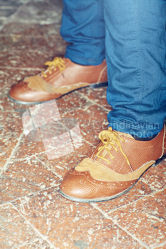 Image of Footwear, style and closeup of man feet by brick floor for elegant, stylish and trendy outfit. Fashion, shoes and zoom of male person with luxury, classy and expensive fashion with jeans by pavement.