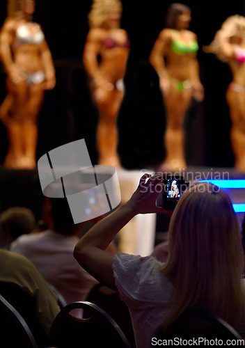 Image of Audience, woman and fitness of bodybuilder or beauty pageant for photography, judge or competition. Female person for photograph, picture or capture of professional models in bikini or lingerie