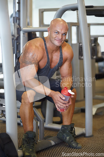 Image of Man in gym, bodybuilder and muscle with portrait, muscle training and protein shake, exercise and strong body. Workout, fitness and bodybuilding, drink for hydration and health with power and smile