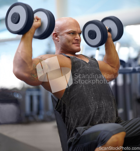 Image of Arm press, man and dumbbell for fitness at gym with bodybuilder, cardio and muscle at health club. Wellness, athlete and exercise machine with weight and strain from bodybuilding, sport and workout