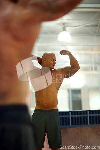 Image of Strong man, arm flexing and mirror at gym with fitness, workout and exercise of bodybuilder with reflection. Muscle, male person and athlete with training, wellness and body builder at a health club
