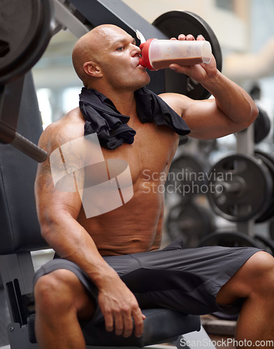 Image of Man in gym, bodybuilder and drinking shake for fitness, training exercise and strong body with protein. Workout, health and bodybuilding, wellness with healthy beverage for hydration and power