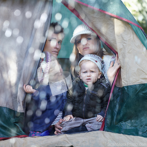 Image of Camping, family and parents with children in rain sad for adventure, holiday and vacation in winter outdoors. Disappointed, unhappy and mother, father and kids in tent with bad weather for travel