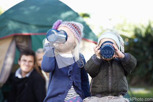 Image of Children, siblings and together for drinking while camping in Sweden, woods or forest on trip. Girl, boy and enjoyment of delicious, beverage or hot cocoa with cup, family and adventure in nature