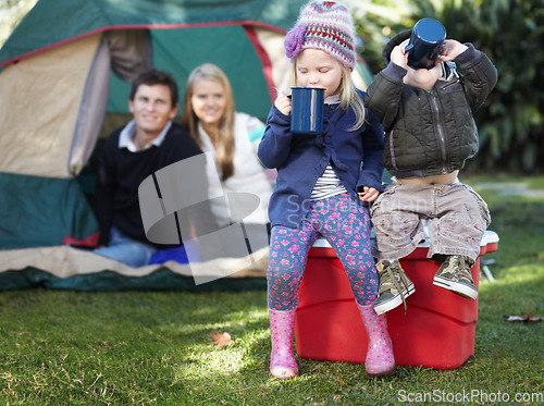 Image of Morning, coffee and family in nature for camping, relax and children bonding with a drink. Happy, parents and siblings or kids with tea or cacao while at a park for a holiday, vacation or camp