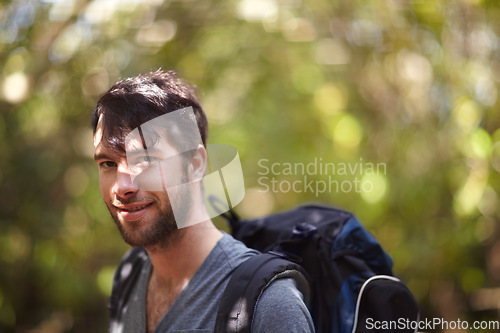 Image of Portrait, man and smile for hike in forest for fitness, wellness or travel in Sweden. Face, person and backpack with supplies for trip, camping or adventure in nature, fresh air and plants in woods