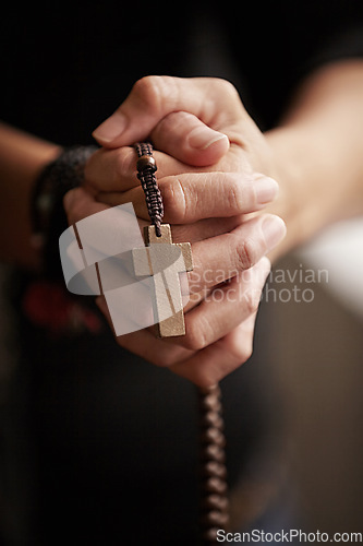 Image of Hands, prayer with beads and worship for religion, trust and spiritual wellness with hope, peace and love. Support, mindfulness and person in Christian faith praying, gratitude and rosary with cross.