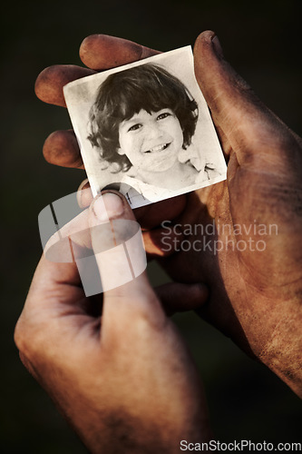 Image of Hands, holding picture of kid and portrait, nostalgia or remember memory of family or child isolated on black background in studio. Closeup, photo of boy and dirty fingers of homeless man in poverty