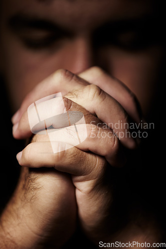 Image of Praying, hands and man for faith, hope and religion or asking for help with mental health, depression or worship in dark room. Sad Christian person with peace, spiritual guidance and God for support