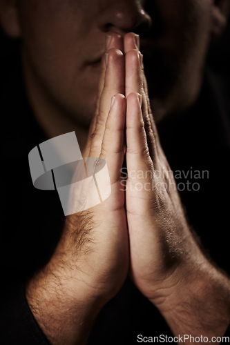 Image of Praying, hands and person for faith, hope and religion or asking for help with mental health, depression or support in dark room. Prayer emoji for peace, spiritual guidance and God or worship closeup