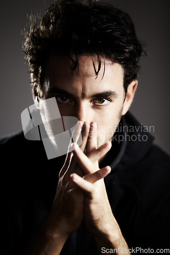 Image of Dark, mystery and portrait of a man on a black background for agent, detective or spy work. Young, looking and a person with the mafia on a backdrop for a target, fear or staring on a backdrop