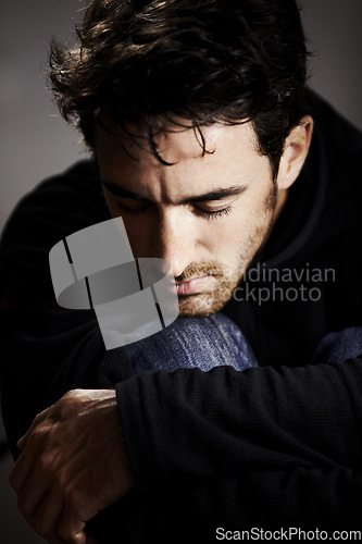 Image of Man, sad or depression with mental health and pain, stress or burnout, financial or life crisis on grey background. Emotion, thinking of trauma and abuse, bankruptcy or debt with psychology in studio