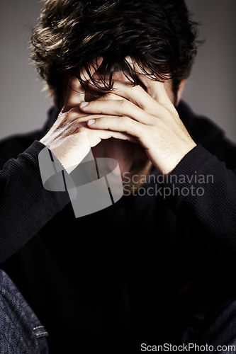 Image of Man, sad or depression with mental health and thinking about pain, stress or burnout with financial crisis and life. Hands, trauma in studio and bankruptcy with debt and disaster on grey background