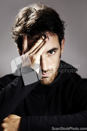 Image of Sad, portrait and a man with depression on a studio background for mental health or mindset. Stress, frustrated and a person with anxiety, fail or a mistake with a disaster or crisis on a backdrop