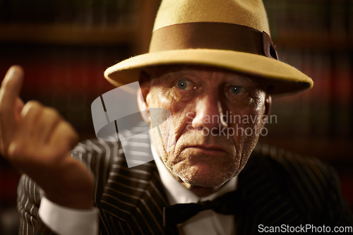Image of Mature, mafia and boss with serious look on face with fearless threat, power and reputation for organized crime. Elderly person, mob and gangster for vintage fashion, suit and bowtie in space