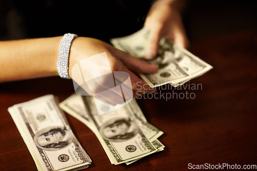 Image of Woman, hand and count dollar money for rich winning, cash deal or secret wealth fraud. Female person, jewellery or crime banking scam or finance for pay profit bribe, exchange or illegal bills notes