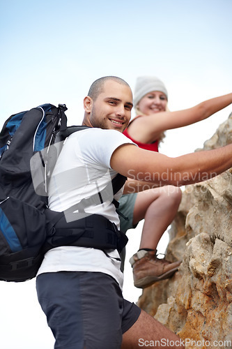 Image of Couple in portrait, rock climbing and hiking adventure in mountain with nature, freedom or power. Travel, trekking and hanging, man and woman on cliff for natural outdoor journey together in fitness.