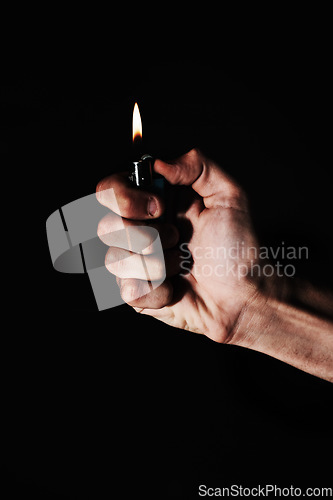 Image of Hand, lighter and fire on black background, heat or warm element, ignite and glow with person in studio. Burning, flame and mockup space, fuel or gas with power, thermal and light, abstract and spark