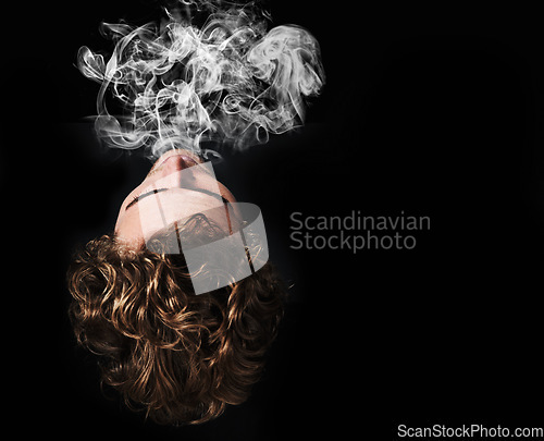 Image of Man smoking marijuana, drugs or cigarette in studio isolated on black background mockup. Smoke, vape and person exhale cannabis, weed and addiction to tobacco, 420 cbd or substance abuse in top view