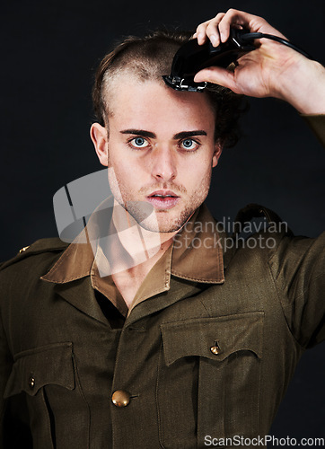 Image of Military, soldier and portrait of man in haircut at studio isolated on a black background. Army, serious face and person shave hair with machine for grooming to prepare for service, bootcamp and war