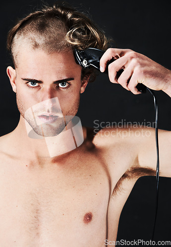 Image of Portrait, body and serious man shaving hair or head in studio isolated on a black background. Face, haircut machine and naked person at hairdresser salon with trimmer for wellness, care and hairstyle