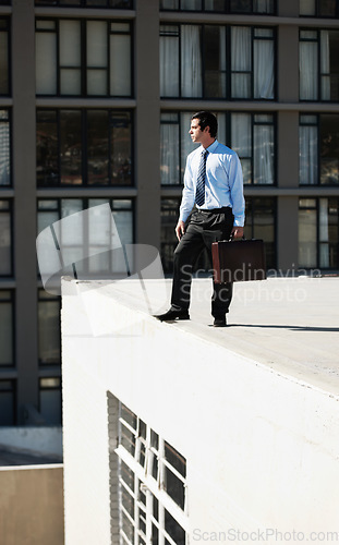 Image of Businessman, suicide and roof with stress, depression and mental health with suitcase outdoor in city. Professional, person or employee on rooftop of building with anxiety, risk, crisis or suffering