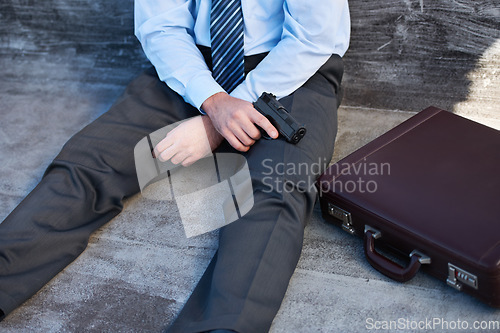 Image of Businessman, hands and gun with suicide, stress and depression on ground with suitcase for risk or problem. Professional, person or employee with weapon on floor for mental health, anxiety and sad