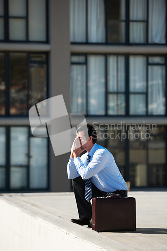 Image of Businessman, suicide and roof with stress, depression and mental health with suitcase outdoor in city. Professional, person or employee and rooftop of building with anxiety, risk, crisis and unhappy