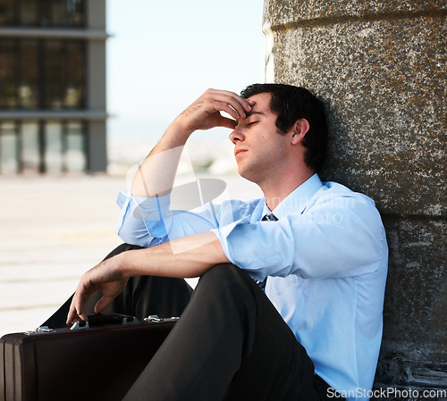 Image of Businessman, headache or outdoor with stress, depression and anxiety on roof of building for crisis. Professional, person or employee with suitcase, mental health or migraine for problem or suffering