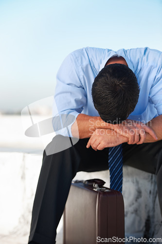 Image of Business, man and outdoor with stress, depression and mental health with suitcase on rooftop in city. Professional, person or employee on roof of building with anxiety, risk and suffering with crisis