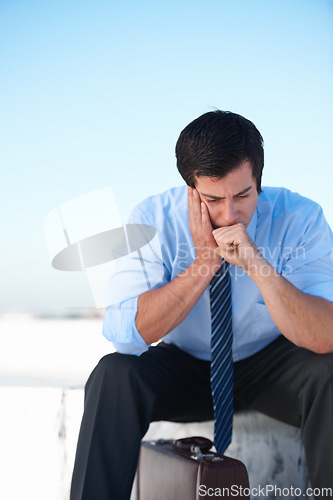 Image of Businessman, headache or stress from depression or anxiety on rooftop of building with suitcase for risk or problem. Professional, person or employee with briefcase or worry on roof for mental health