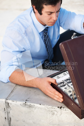 Image of Businessman, person or briefcase with money or crime and corruption, thief or fraud outdoor for financial crisis. Professional, man or face with contemplation for cash, finance and secret with stress