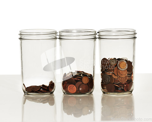 Image of Money, jar and coins on a white background for finance, investment and financial growth. Accounting, economy and container with cash for savings, profit and wealth for budget, donation and payment