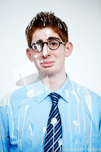 Image of Portrait, bird poo and a business man in studio on a white background for an unlucky or misfortunate mishap. Sad, depression and bad luck with an unhappy young employee in glasses after an accident