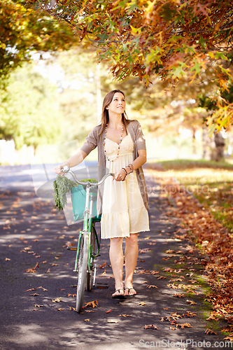 Image of Bicycle, woman and nature for fitness in cycling, summer vacation and eco friendly park with wellness and exercise. Norway, person and trendy fashion in garden, sustainability and happy in cityscape