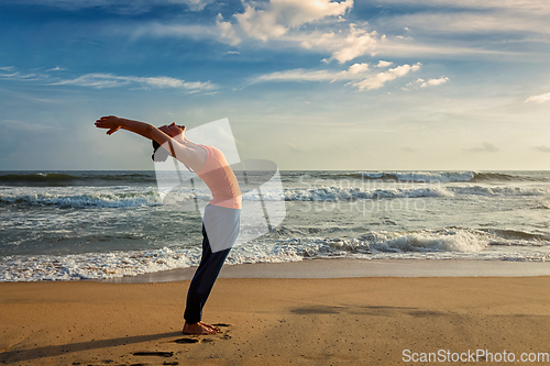 Image of Woman doing yoga Sun salutation Surya Namaskar