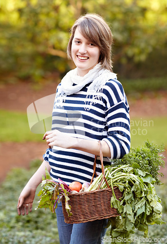 Image of Harvest, basket and portrait of woman with vegetables from gardening in backyard. Happy, person and container with healthy produce, fruits or plants from farming agriculture or garden in countryside