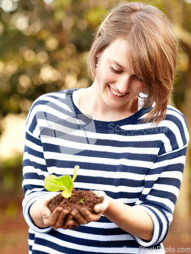 Image of Woman, hands and plant for hope, future or growth in eco farming in sustainability in environment. Female worker, farmer and smile for care of sapling in soil for agriculture, fresh produce or change