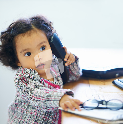 Image of Little girl, phone and call play for imagine, communication or childhood funny joke. Female person, learning development and landline talking for game telephone or career growth fun and comedy