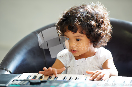 Image of Girl, child and keyboard music play for childhood learning, education development or lessons. Female person, kid and piano keys song or instrument training knowledge, youth artist or future musician