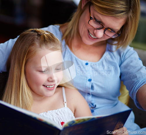 Image of Reading, story and mother with child in home with smile, learning and relax with study knowledge. Storytelling, happy mom and girl on library couch together with books, fantasy and education.