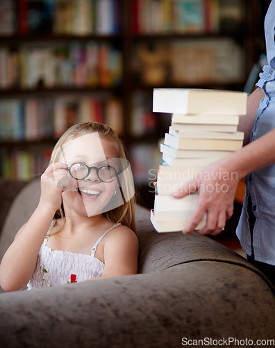 Image of Smile, stack of books and kid in library, learning and relax, studying homework knowledge on couch. School, woman and girl child with glasses in bookstore together with story, and education on sofa.