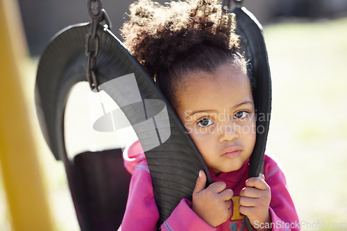 Image of African kid, swing and portrait outdoor at school, park or kindergarten with playful games in spring. Child, nature and development with freedom, adventure and learning in nature, summer and sunshine